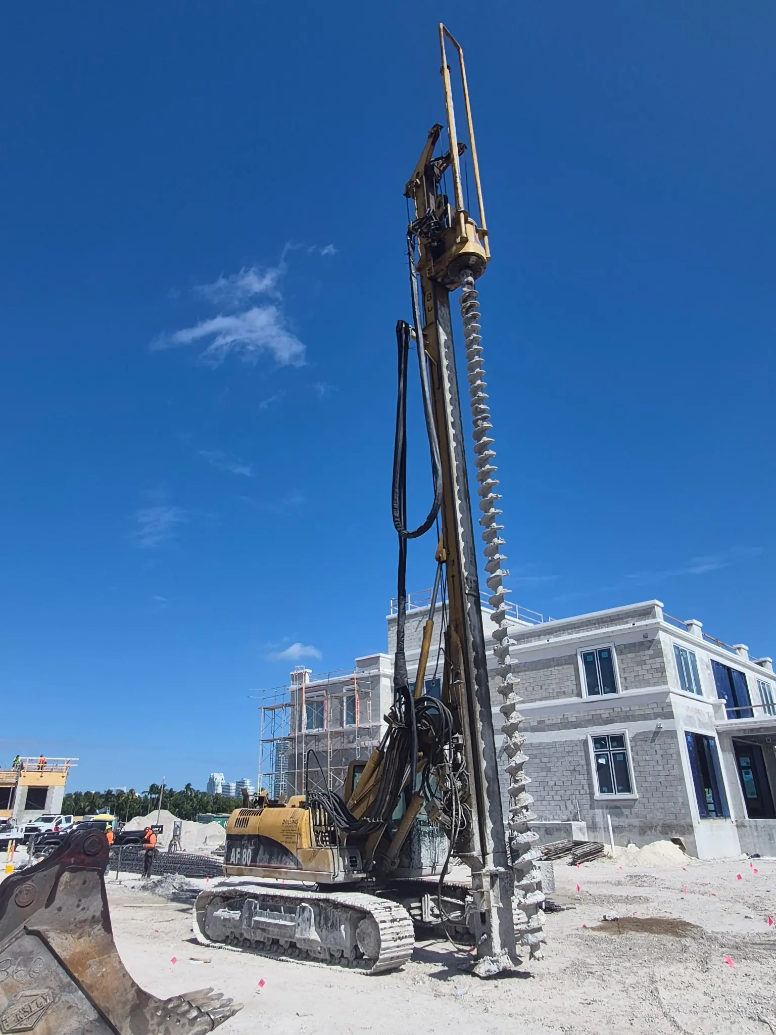 Continuous flight auger extended against a clear blue sky