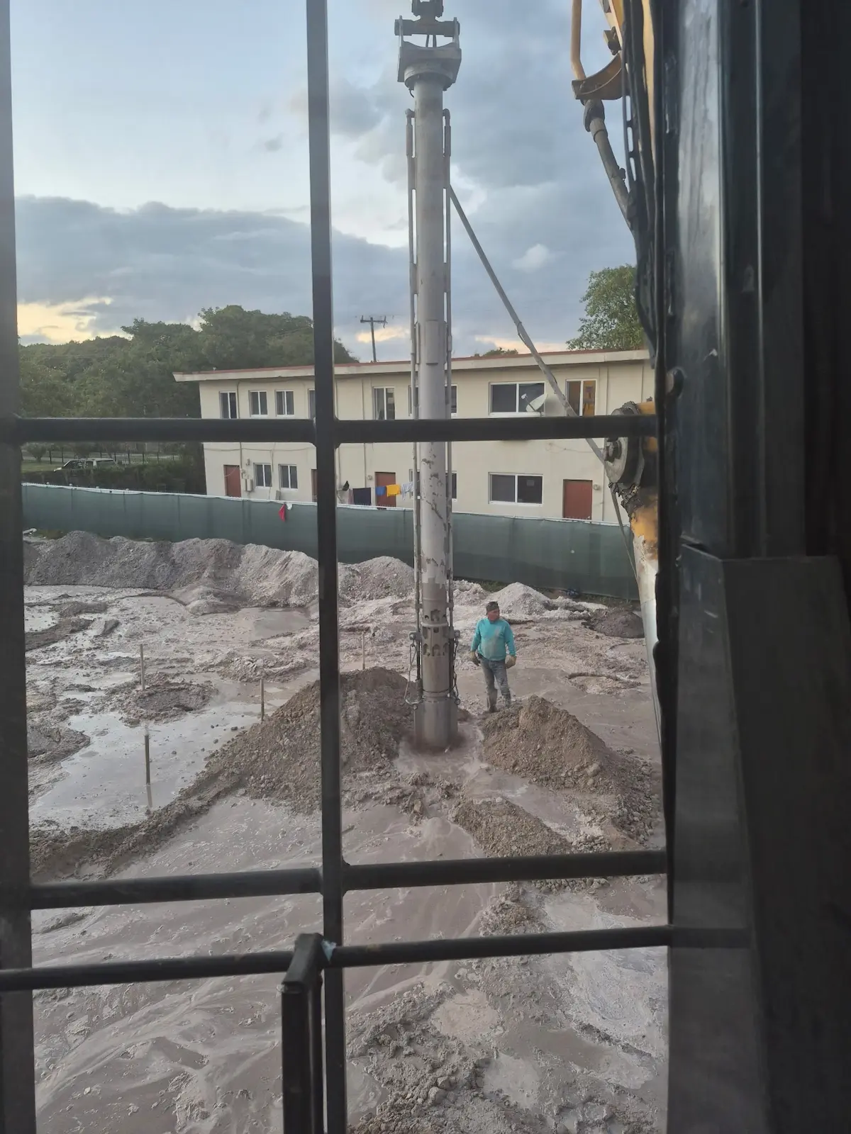 Worker at the graded foundation site